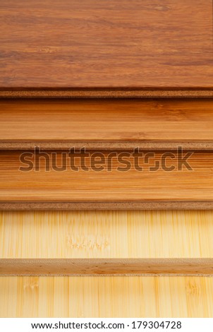 Stack of bamboo laminate flooring samples close up