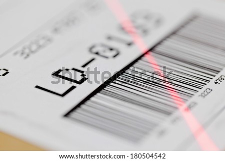 Barcode on shipping label on box scanned by automatic laser scanner