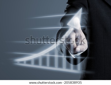 Businessman drawing success graph on virtual futuristic computer display