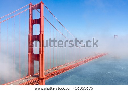 Famous Golden Gate Bridge in San Francisco partly covered in fog