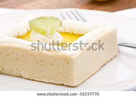 Delicious lemon tart cake on plate with fork
