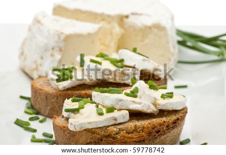 Delicious brie cheese on fresh sliced bread with chives