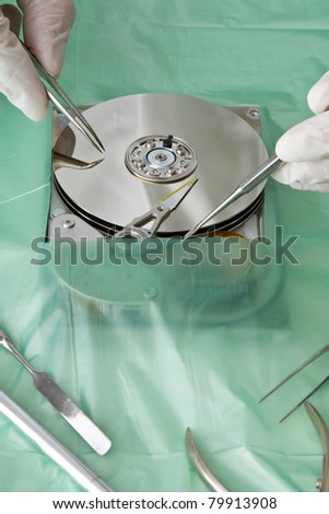 Technical surgeon working on hard drive - data recovery concept