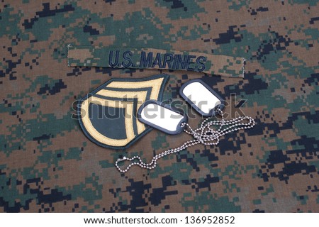 US  Marines concept with service tapes, dog tags and camouflaged uniform
