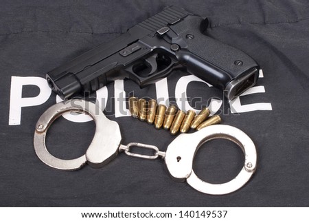 security concept with gun ammo and handcuffs