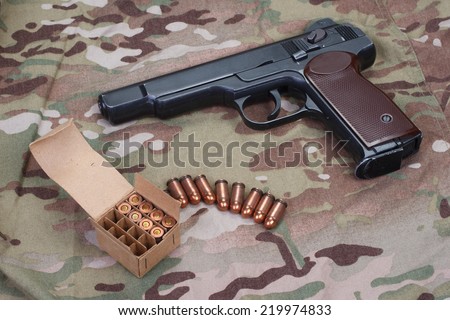 Stechkin automatic pistol APS on camouflage background