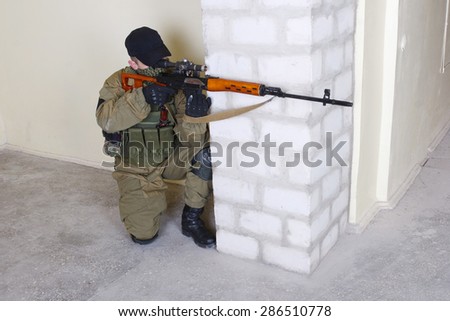 mercenary sniper with sniper rifle inside the building