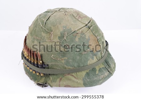 US Army helmet with camouflage cover and ammo belt - Vietnam war period isolated
