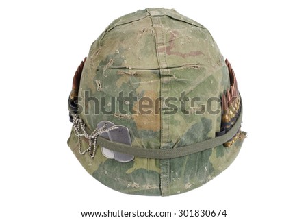 US Army helmet with camouflage cover and ammo belt and dog tags - Vietnam war period