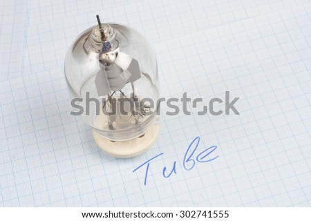 old vacuum tube (electron tube) on graph paper background