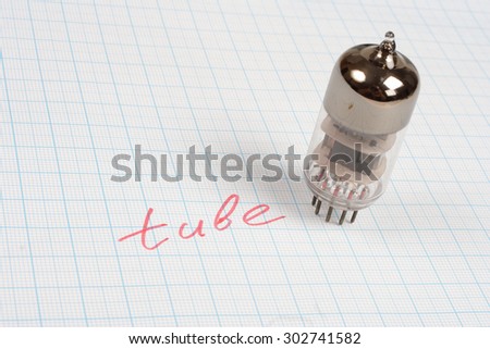 old vacuum tube (electron tube) on graph paper background