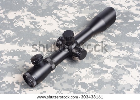 sniper scope on camouflage background