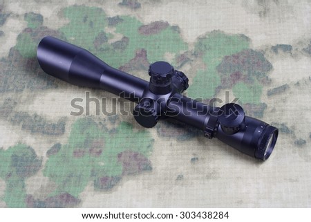 sniper scope on camouflage background