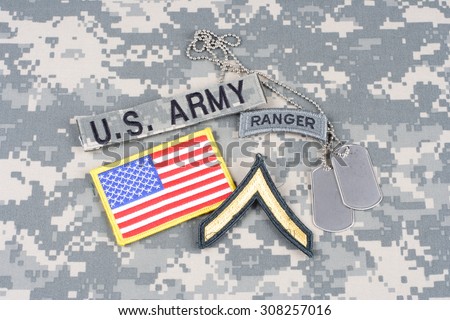 KIEV, UKRAINE - August 21, 2015. US ARMY Private rank patch, ranger tab, flag patch,  with dog tag on camouflage uniform