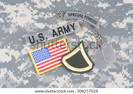 KIEV, UKRAINE - August 21, 2015. US ARMY Private First Class rank patch, special forces tab, flag patch,  with dog tag on camouflage uniform