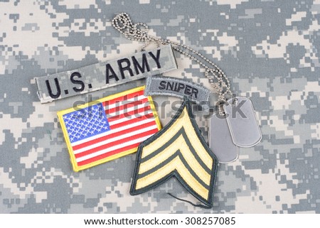 KIEV, UKRAINE - August 21, 2015. US ARMY Sergeant rank patch, sniper tab, flag patch,  with dog tag on camouflage uniform