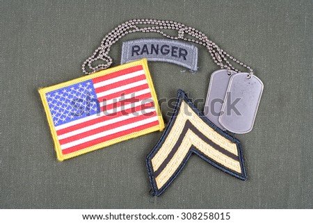 KIEV, UKRAINE - August 21, 2015.  US ARMY Corporal rank patch,  ranger tab, flag patch and dog tag on olive green uniform