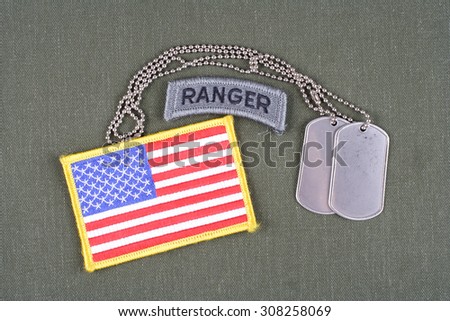 KIEV, UKRAINE - August 21, 2015. US ARMY ranger tab with dog tag and flag patch on olive green uniform
