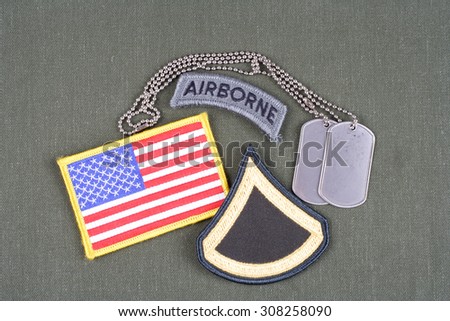 KIEV, UKRAINE - August 21, 2015.  US ARMY Private First Class rank patch, airborne tab, flag patch and dog tag on olive green uniform