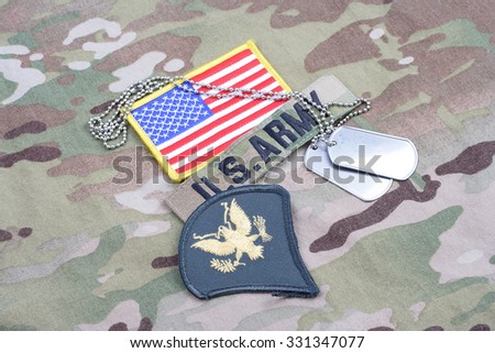 KIEV, UKRAINE - September 5, 2015. US ARMY Specialist rank patch, flag patch, with dog tag on camouflage uniform