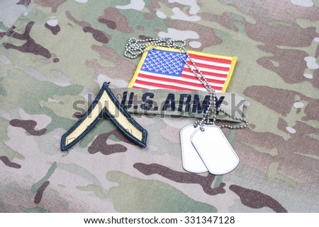 KIEV, UKRAINE - September 5, 2015. US ARMY Private rank patch,  flag patch, with dog tag on camouflage uniform