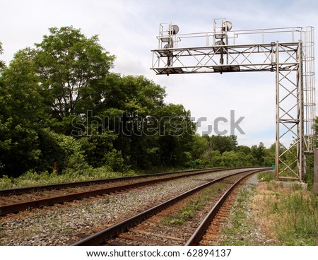 Train tracks diminishing behind the semaphore signal lights