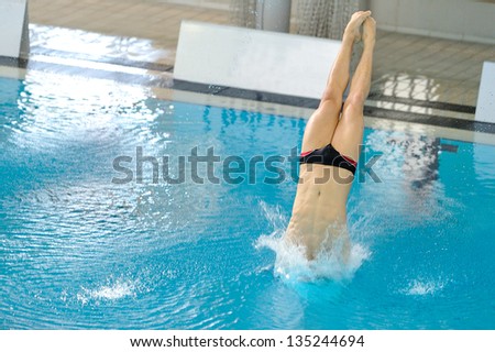 Indoor diving in a pool with negative space for text