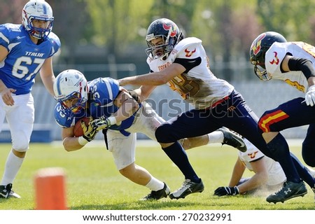 TURIN, ITALY - APRIL 12, 2015: LATORRE SANHO Vicent (right) stops CUOMO Valerio (left). Italian U19 team win the qualifying match with Spain for European championship, in the Nebiolo Stadium in Turin.