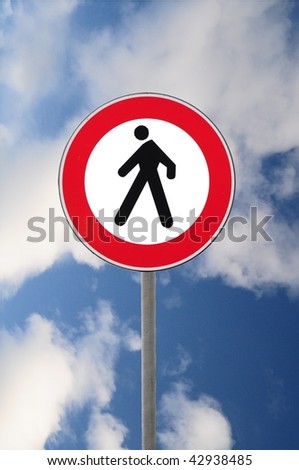 Road sign transit interdiction to pedestrian on sky background