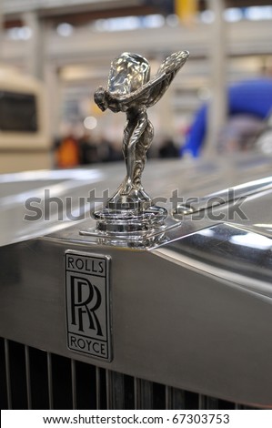TURIN - FEB 14: Rolls Royce sign and statue on display at the Automotoretro Auto Show on February 14, 2010 in Turin, Italy. The event is a great old and vintage auto shows in Italy.