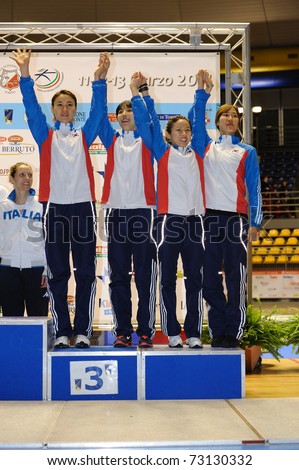 TURIN, ITALY - MARCH 13: Korea team (JEON, NAM, OH, SEO) stands at first place podium of team tournament of the 2011 Women world fencing cup on March 13, 2011 in Turin, Italy