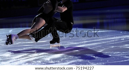 Ice figure skating pair with shadows on ice