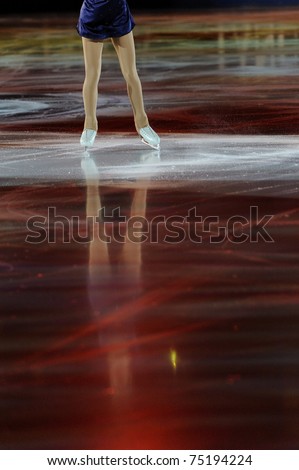 Ice figure skating woman legs on ice with shadows