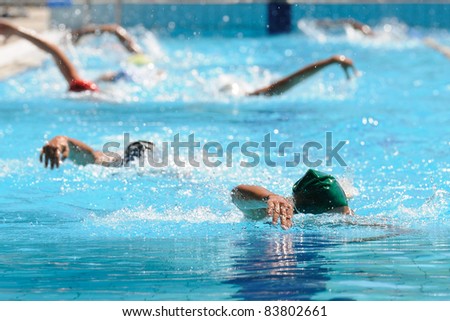 People swimming in a open air pool