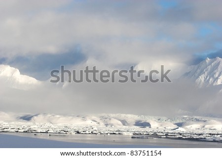 Typical Arctic winter landscape - mountains, sea, glaciers