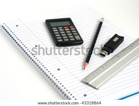 usb memory stick calculator ruler and pencil on white lined notepad