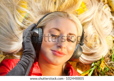 beauty girl listening music in the park