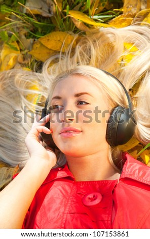 beauty girl listening music in the park