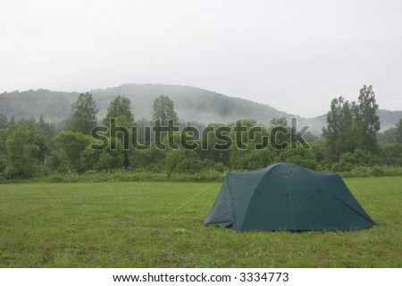 landscape with summer morning fog and tent