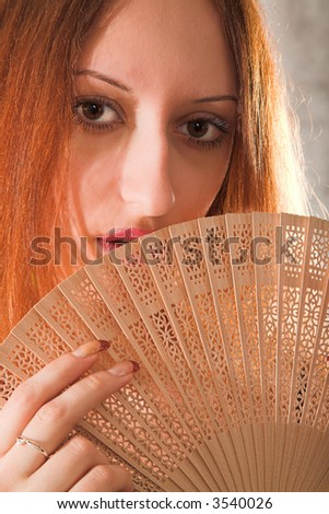 young woman with fan isolated on white