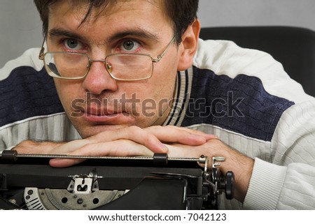 the man in eyeglasses with vintage typewriter