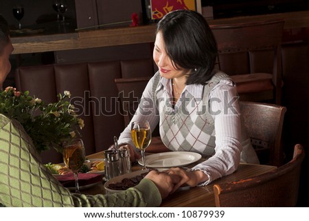 man giving flowers to the woman at restaurant