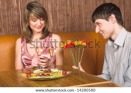 Man presents beautiful flowers to his girlfriend