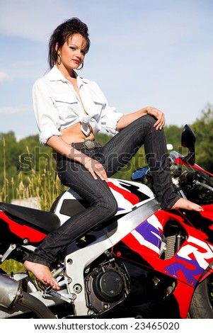 young beauty girl with motorbike on the road