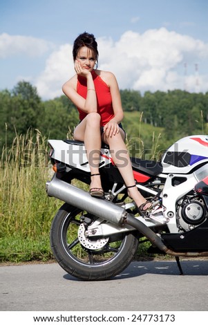 young beauty girl with motorbike on the road