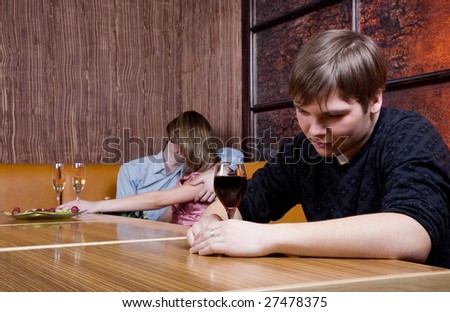 Three young people spend time in cafe