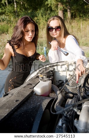 young beauty girl try to repair big car