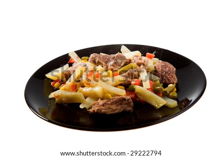 food isolated. meat and vegetables on the black plate