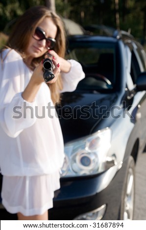 young beauty girl with gun and car