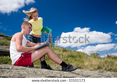 young couple working with computer in the nature reserve